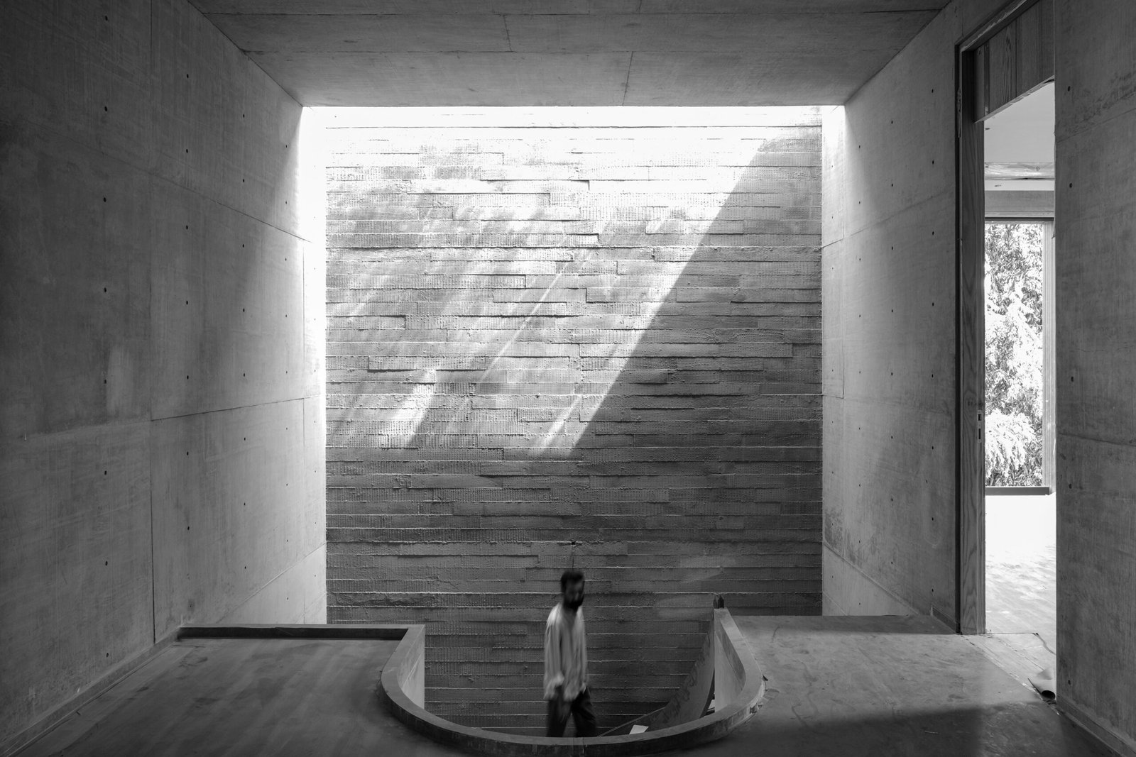 a black and white photo of a person sitting in a room